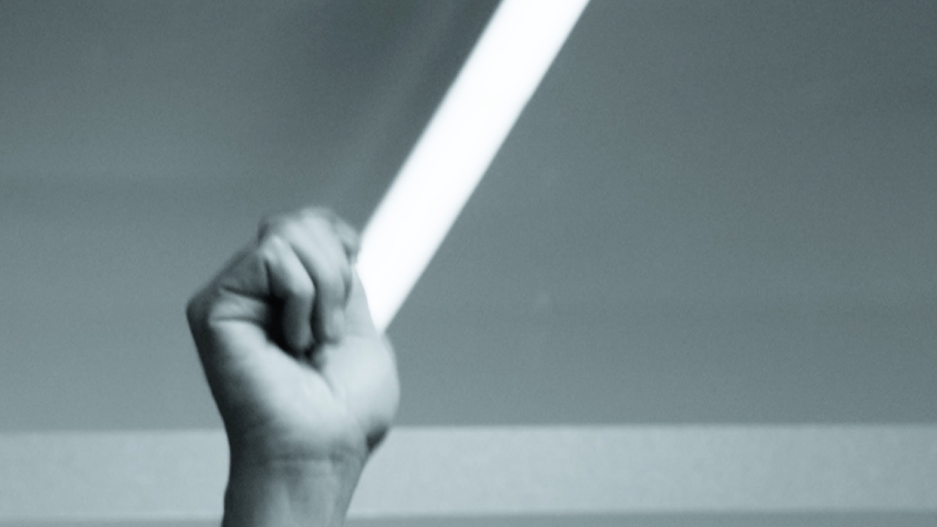 Black-and-white insert of a hand ringing the bell