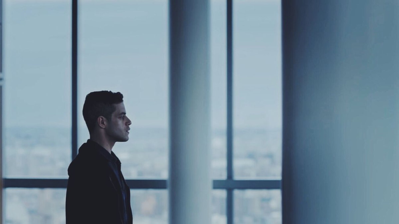 Mr. Robot: a figure in profile, small at the left of a wide frame of windows