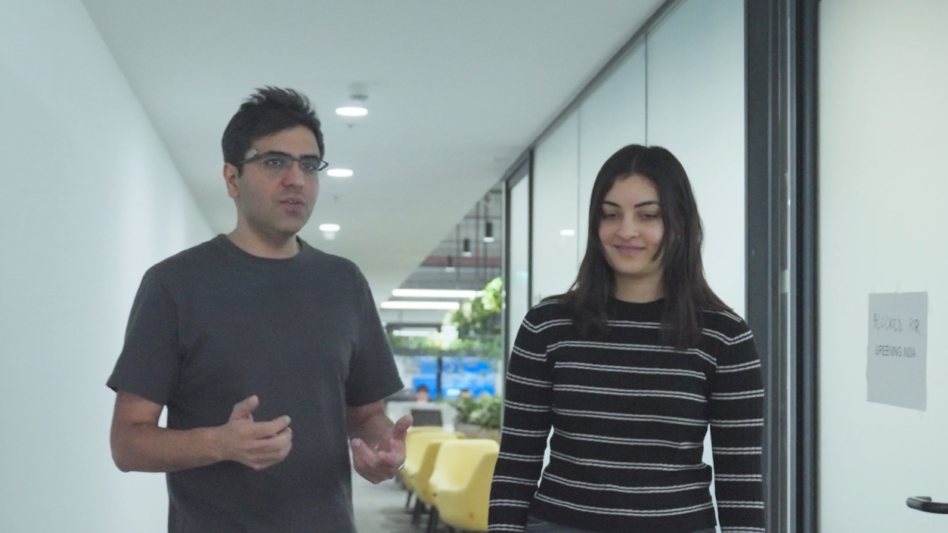 Anubhav and Maahira walking down the corridor towards the cafeteria