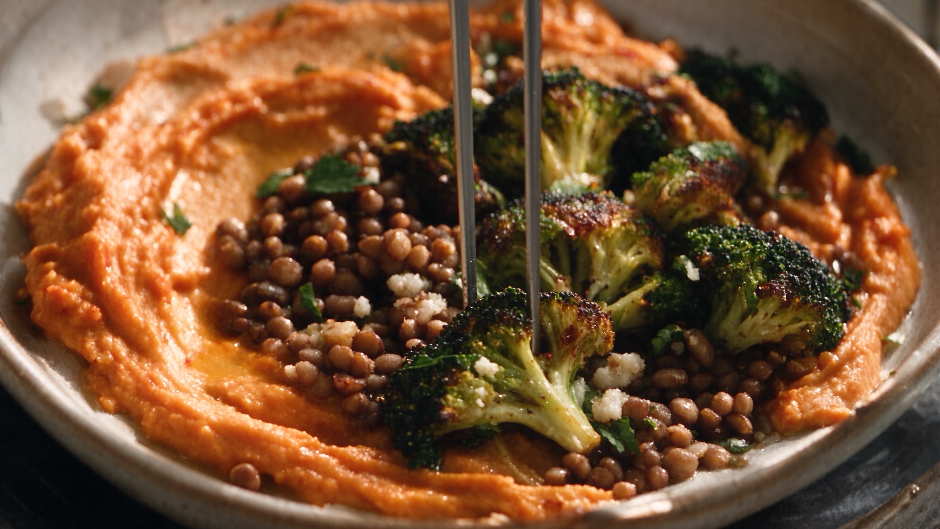 Roasted broccoli and lentils on a swirl of red pepper purée