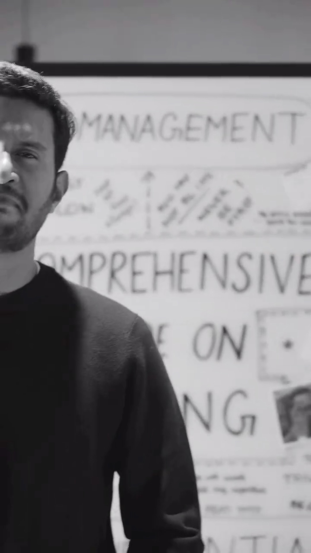 A deadpan look beside the whiteboard